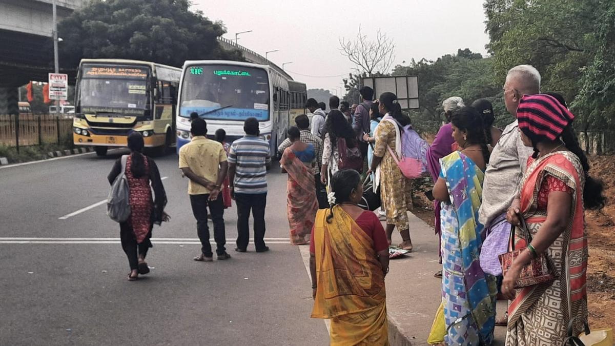 With no seat or shelter, commuters at Mannarpuram bus stop are exposed to the elements